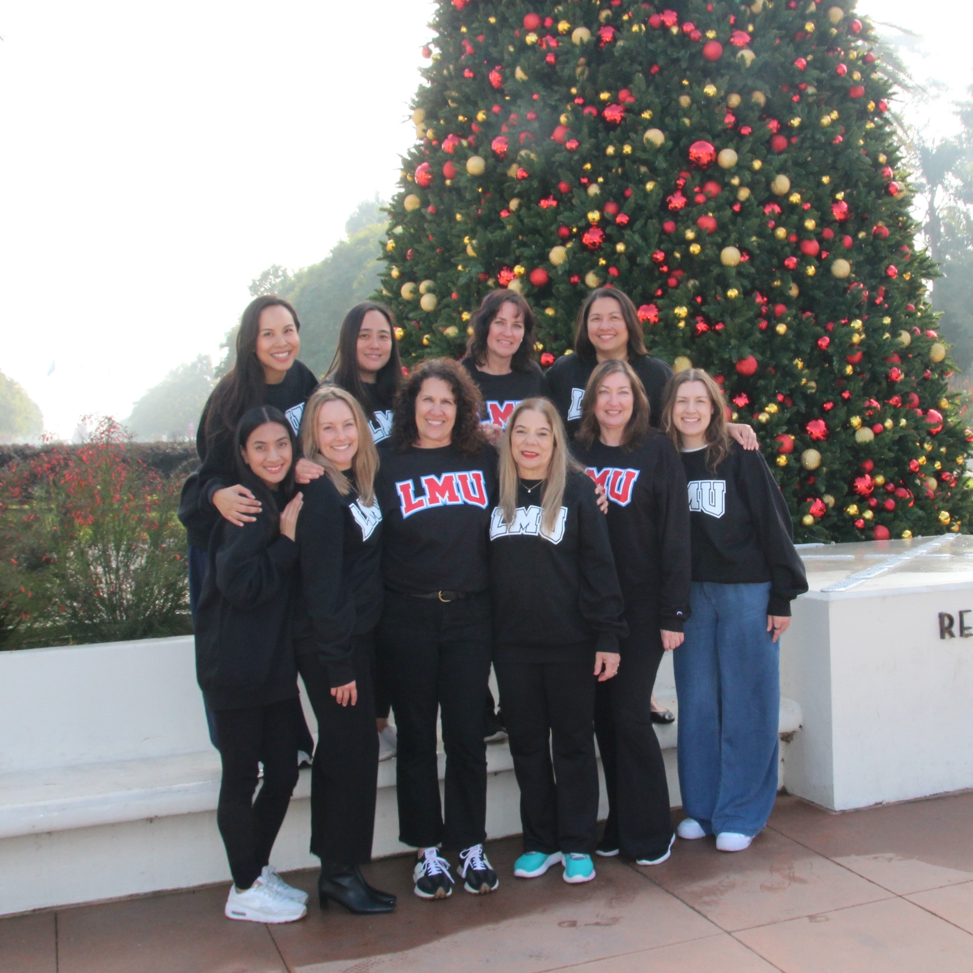 ORSP Team members posed for a group photo next to a christmas tree